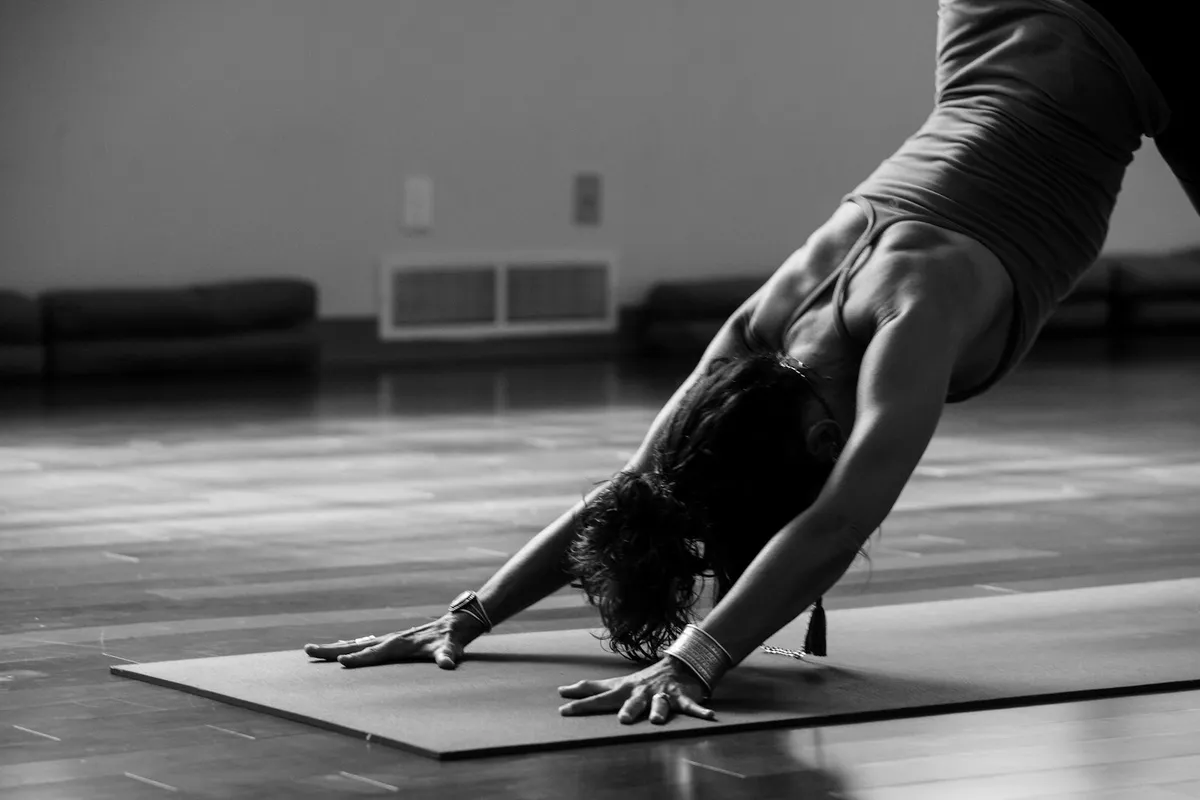 Person in downward-facing dog pose forming an inverted V shape