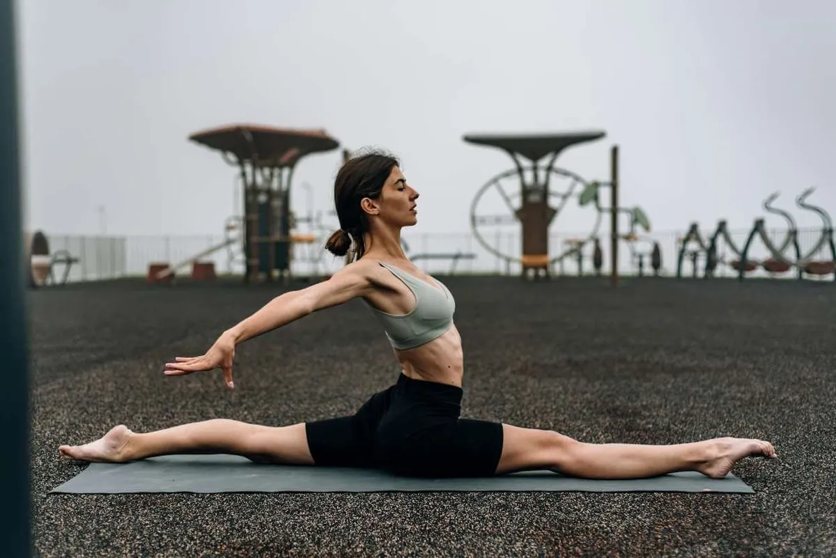 Woman practising a seated stretch to lengthen the back of the legs