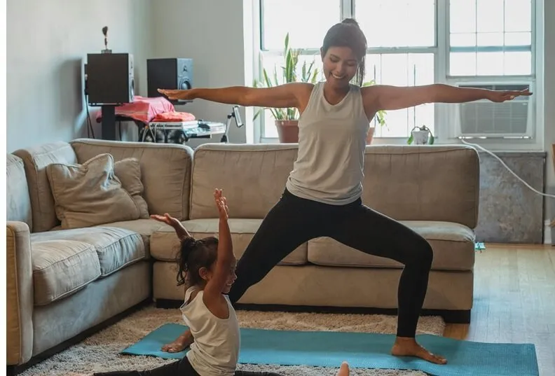 Person holding warrior two pose with the front knee bent and arms extended